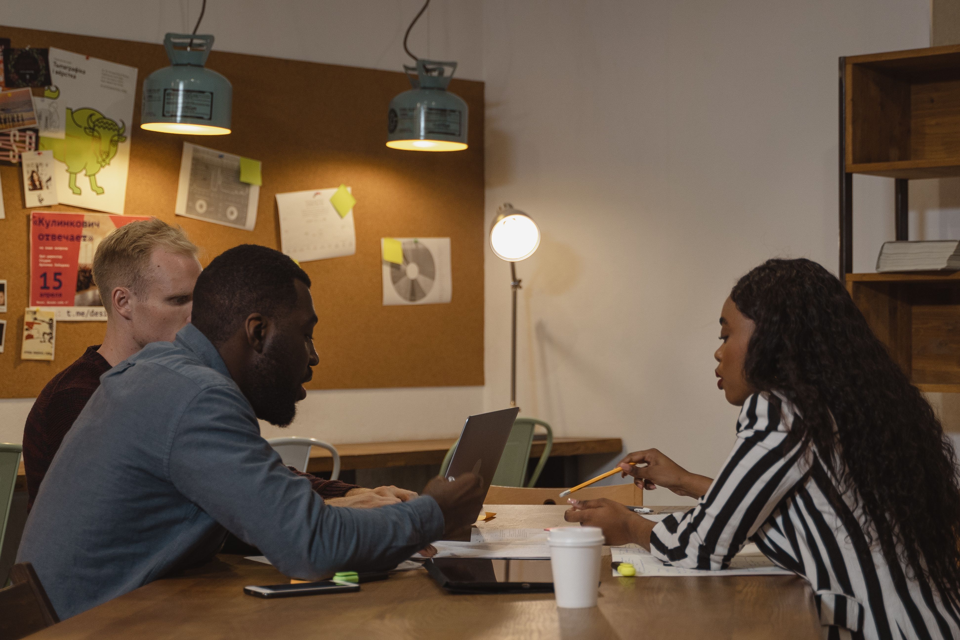A team collaborating around a workspace during a training session